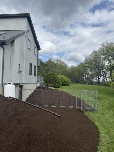 Fresh mulch installation around backyard fence by Justin's Lawn Service