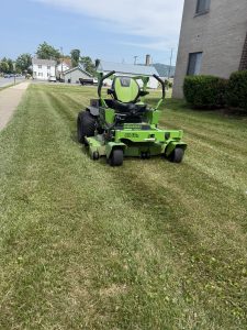 Zero turn mower cutting grass for Justin's Lawn Service